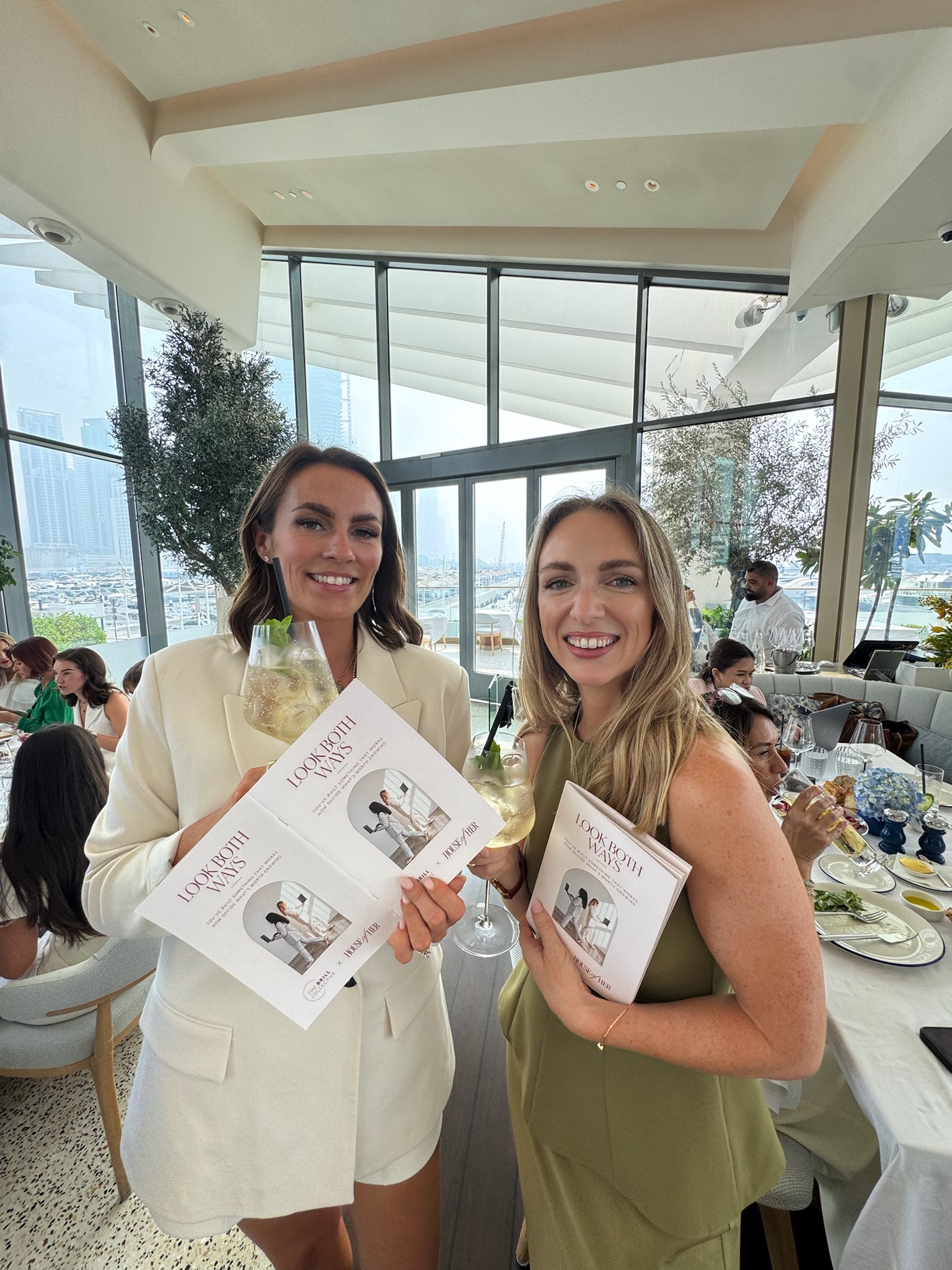 Amy and Cat holding Look Both Ways workshop booklets at the House of Her session
